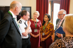 Claire talking to the Chief Constable with other Surrey MPs.